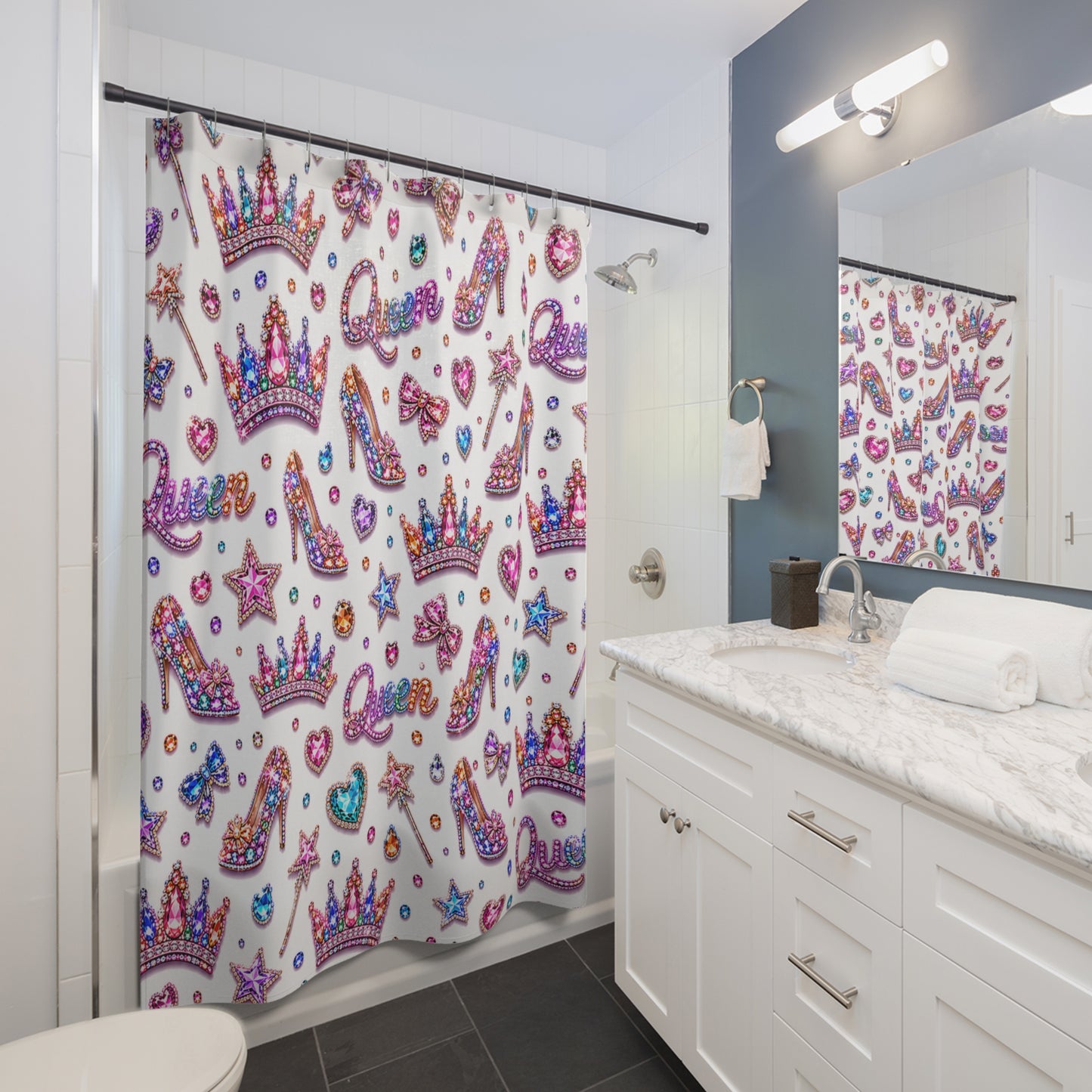 Bathroom with a colorful shower curtain featuring crowns, high heels, and stars.