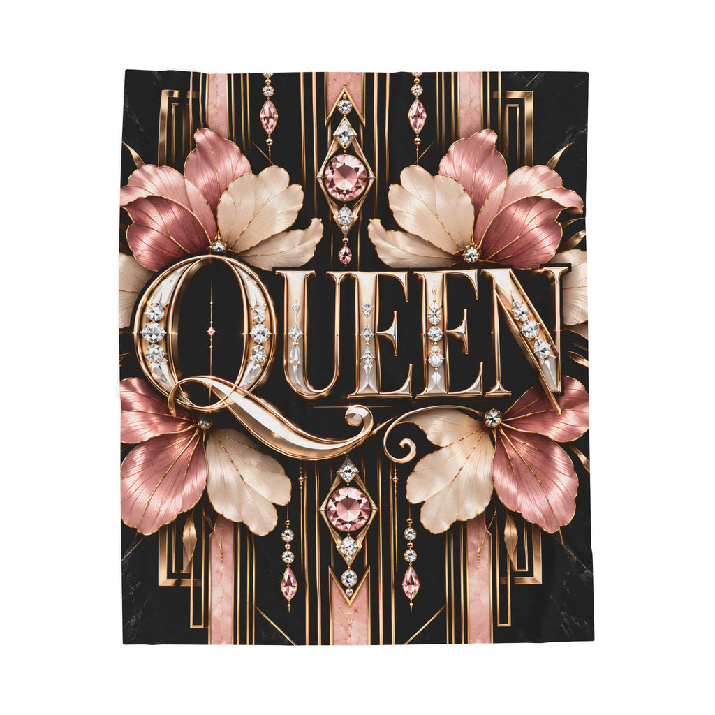 A rectangular decorative blanket featuring the word "QUEEN" in large ornate metallic lettering, surrounded by pink and beige Art Deco-style flowers and geometric details on a black background, shown against a plain white studio backdrop.