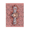 Decorative throw blanket with a leopard design and floral elements on a pink background