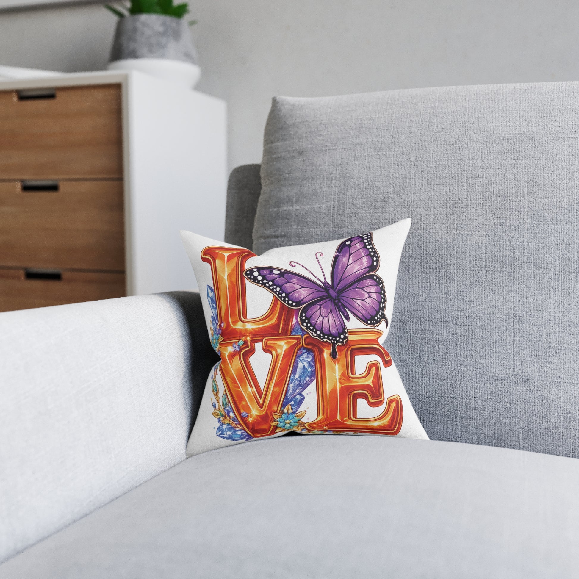 Decorative pillow with butterfly and 'LOVE' text on a gray sofa