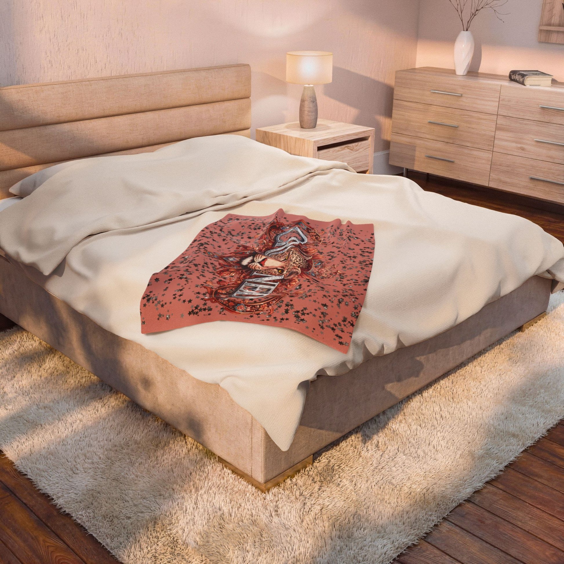 Decorative blanket with a leopard design on a bed in a bedroom setting