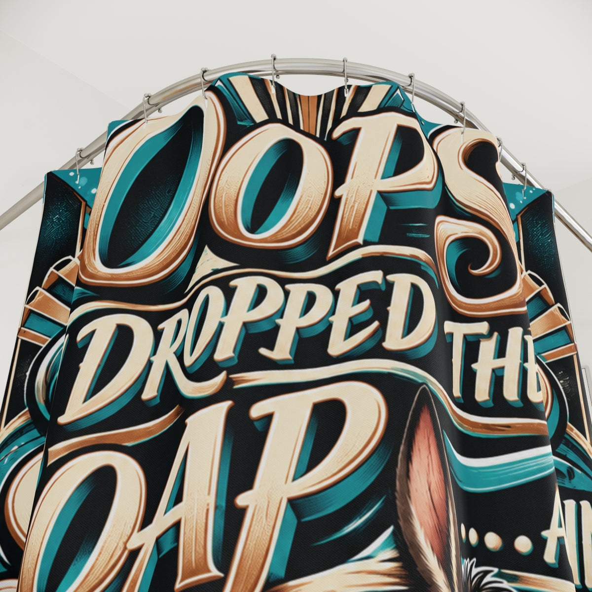 A close-up of a large decorative shower curtain with stylized 3D lettering that reads 'Oops Dropped The Soap.er c