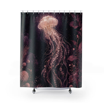 A shower curtain featuring a dark underwater scene with a large glowing jellyfish in pink, peach, and purple tones against a black background, shown hanging on a white studio background with a rod and small feet visible at the bottom.