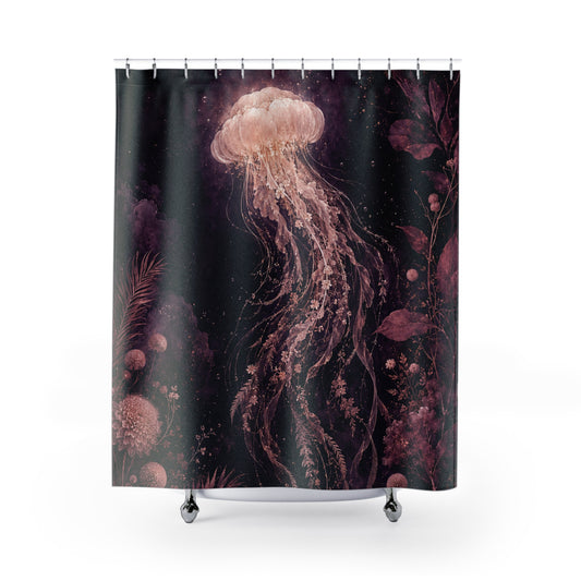 A shower curtain featuring a dark underwater scene with a large glowing jellyfish in pink, peach, and purple tones against a black background, shown hanging on a white studio background with a rod and small feet visible at the bottom.