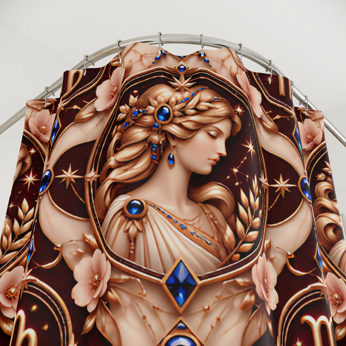 A close-up of a decorative textile or curtain panel featuring an ornate classical-style portrait of a woman with flowing hair, surrounded by gold flourishes, pink flowers, and blue gem-like accents on a dark brown background.