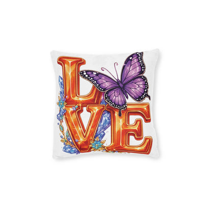 Decorative pillow with 'LOVE' in orange letters and a purple butterfly on a white background