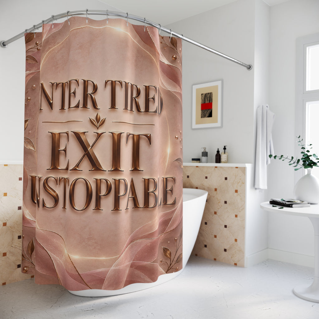 A shower curtain hanging in a bright white bathroom, printed with a metallic rose-gold and copper gradient design featuring the words 'ENTER TIRE EXIT STOPPABLE' in large 3D-style lettering.