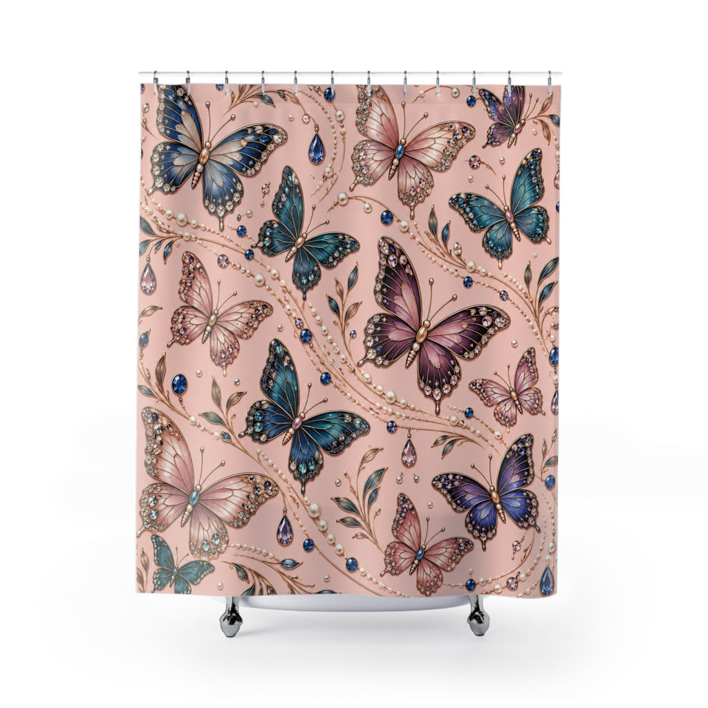 A shower curtain featuring a detailed pattern of colorful butterflies in shades of blue, purple, and pink over a dusty pink background, decorated with delicate gold vine details and small blue gem accents. The curtain is shown hanging from silver rings on a white rod, with the bottom of the curtain resting on a white tub edge.