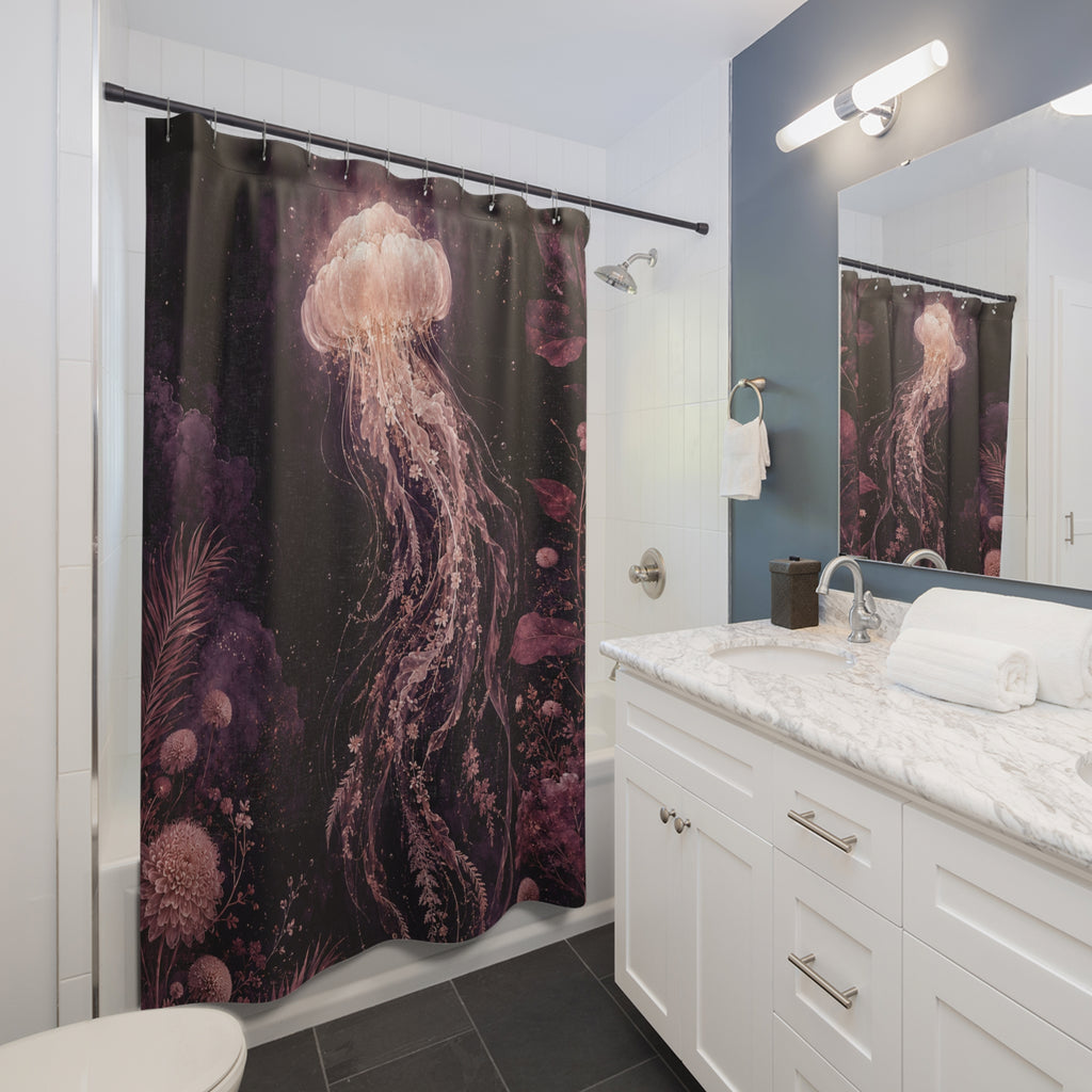 A shower curtain featuring a dark underwater scene with a large pink jellyfish and purple coral, shown hanging in a modern white and blue bathroom with a marble vanity and mirror.