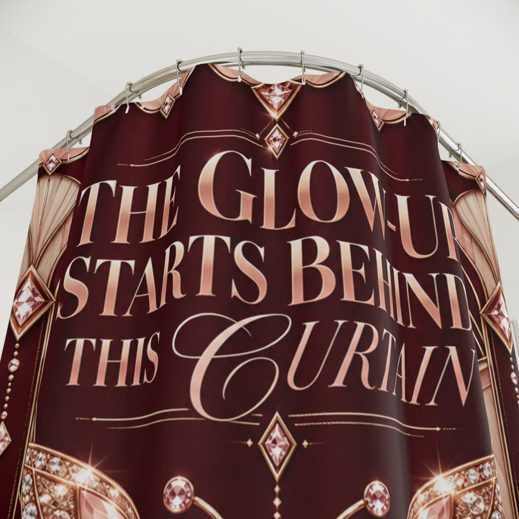 A maroon curtain with rose gold text reading 'THE GLOW-UP STARTS BEHIND THIS CURAIN' and decorative gem motifs, hanging from a metal rod against a light gray background.