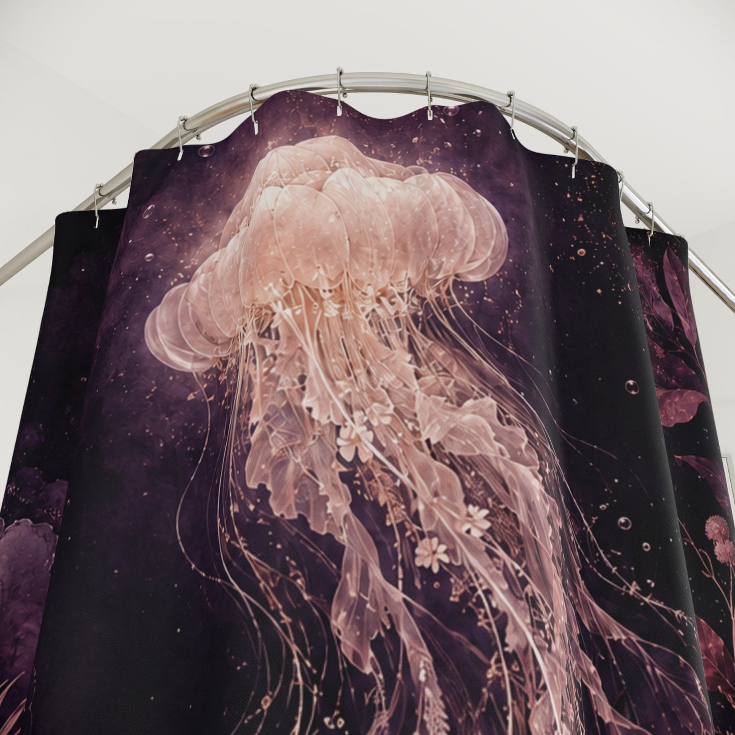A shower curtain featuring a large translucent pink jellyfish design over a dark purple and black cosmic background, hanging from a curved metal rod.