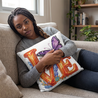 Woman holding a pillow with 'LOVE' and butterfly design in a living room.