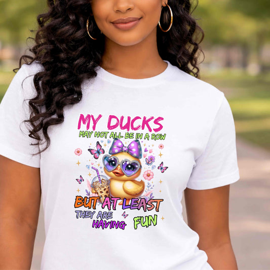 Person wearing a white t-shirt with a colorful graphic and text.