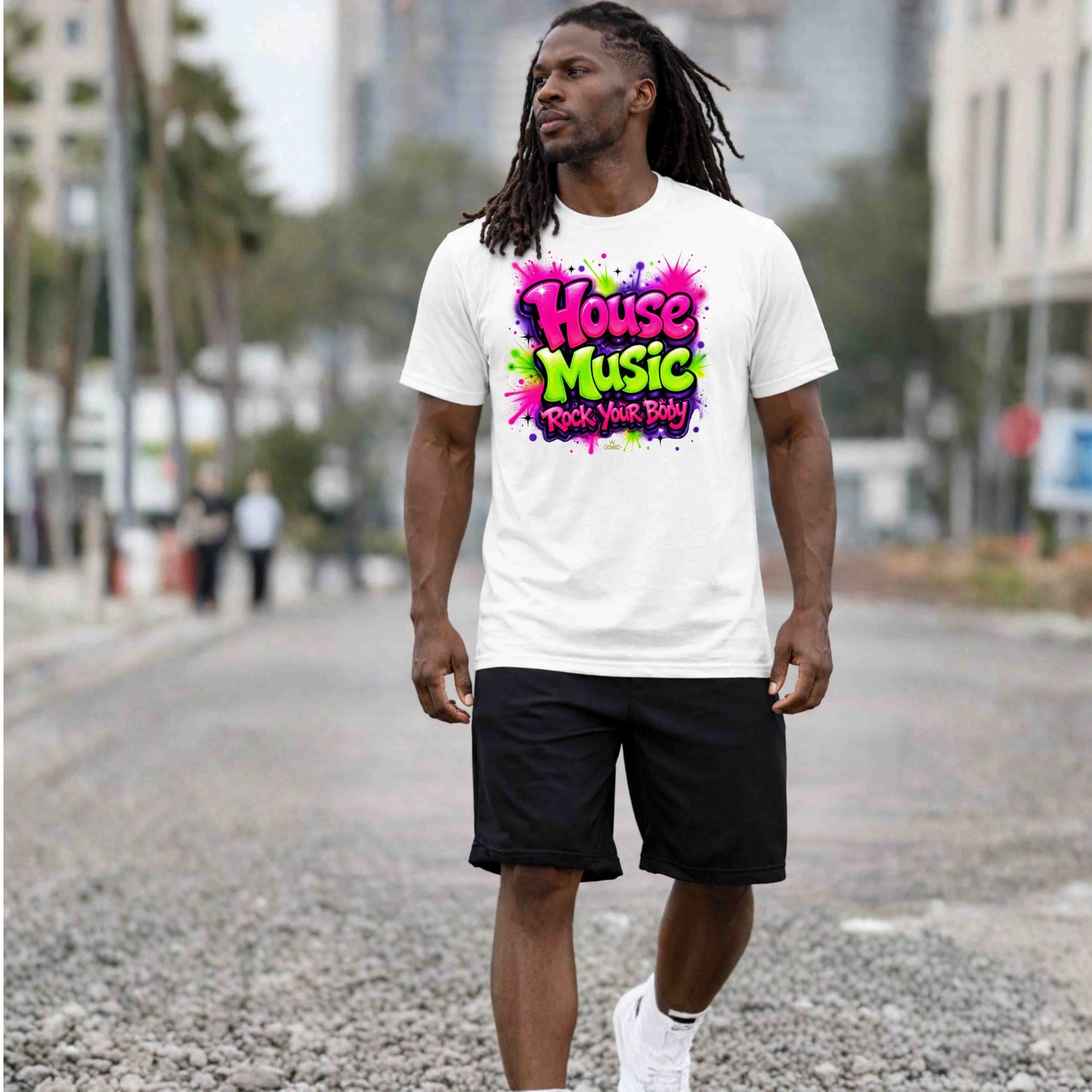 Man wearing a white t-shirt with 'House Music' text walking on a street.