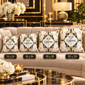 Four decorative throw pillows on a beige sofa in a luxurious gold-and-black living room. The pillows have a cream background with black and gold geometric patterns and the word 'Queen' in the center, with size labels '14 x 14', '16 x 16', '18 x 18', and '20 x 20' overlaid below them.
