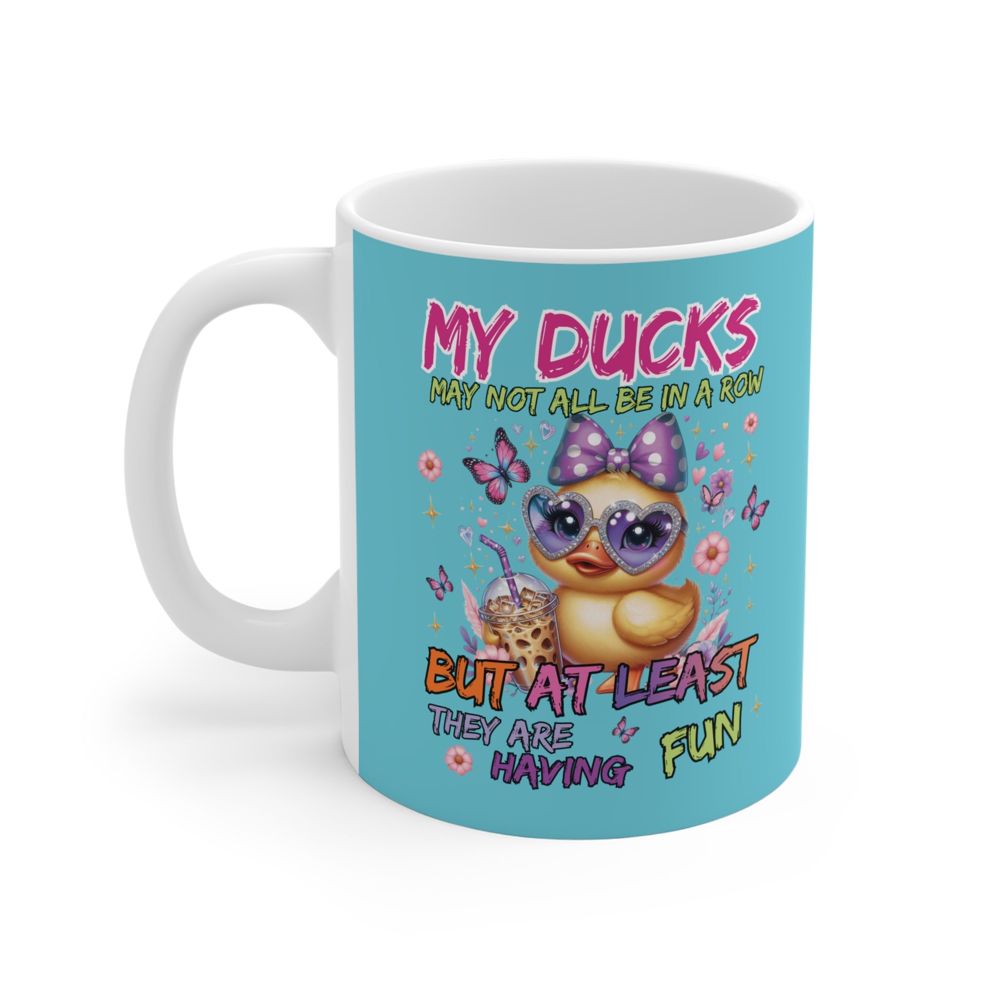 Mug with a cartoon duck wearing sunglasses and a bow, surrounded by flowers and text on a blue background.