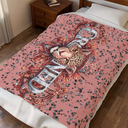 Decorative blanket with a leopard design on a bed in a bedroom setting