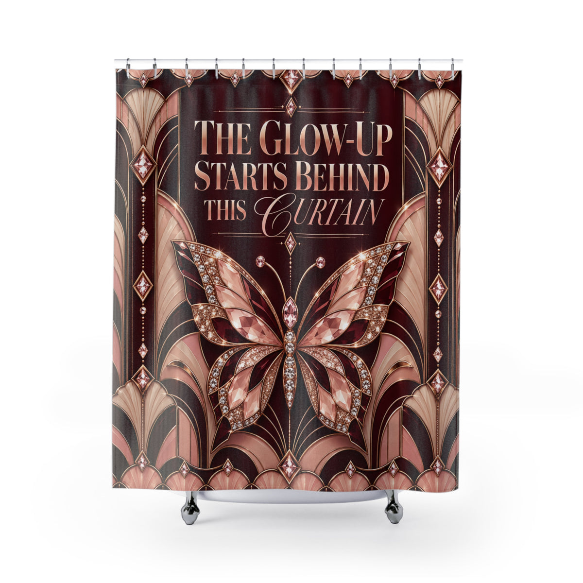 A shower curtain featuring an Art Deco style design with a large jeweled butterfly and the text 'THE GLOW-UP STARTS BEHIND THIS CURTAIN' on a dark brown background, shown hanging in a studio setting.