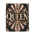 A rectangular black decorative throw featuring ornate Art Deco-style gold and blush pink geometric rays, gem motifs, and the word "QUEEN" in large gold letters with rhinestone-like detailing, shown on a plain white background.