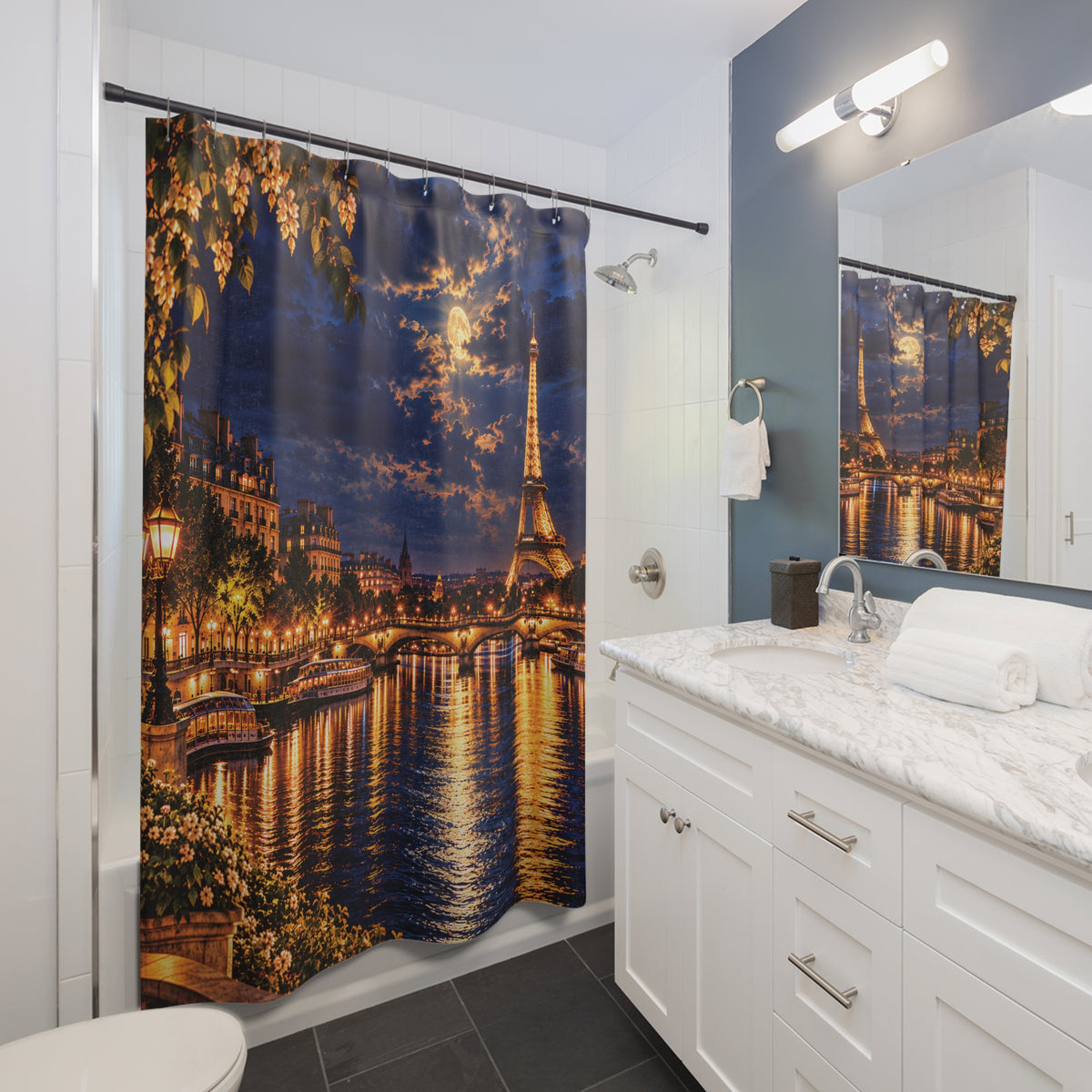 A Paris-themed shower curtain featuring a nighttime cityscape with the Eiffel Tower, glowing streetlights, and reflections on the water, shown hanging in a modern white bathroom with a marble vanity and mirror.