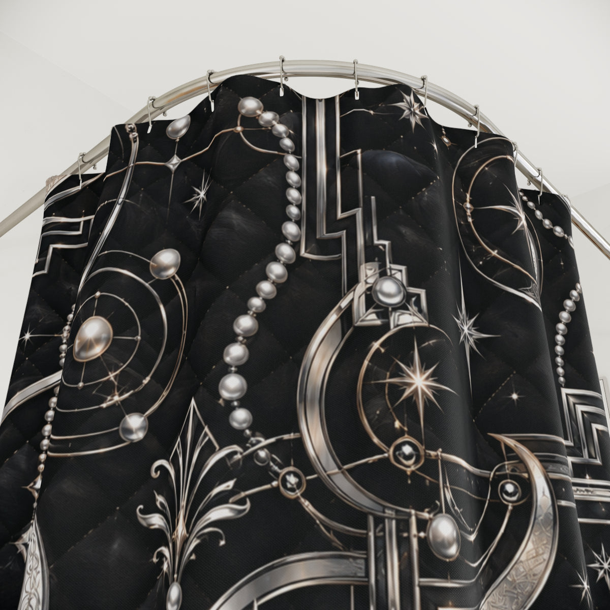 Black quilted curtain panel with a metallic silver celestial print featuring crescent moons, stars, and geometric patterns, hanging from a silver metal rod.