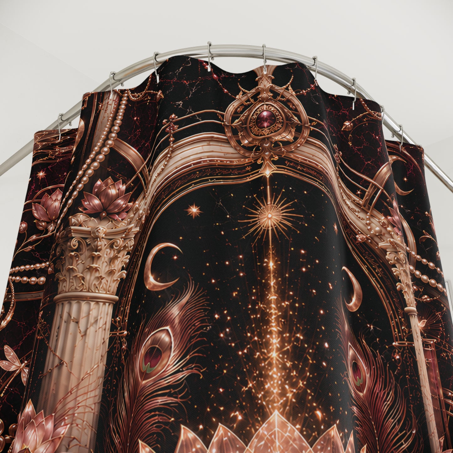 A close-up of a draped shower curtain y featuring an ornate celestial and architectural print. The design has a black background with metallic bronze-gold stars, crescent moons, peacock feathers, lotus flowers, and classical columns, hanging from a curved metal rod against a plain light gray background.