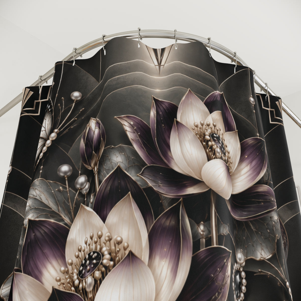 A close-up of a black shower curtain featuring a detailed graphic print of lotus flowers in shades of purple, cream, and metallic gold, hanging from a curved silver metal rod.