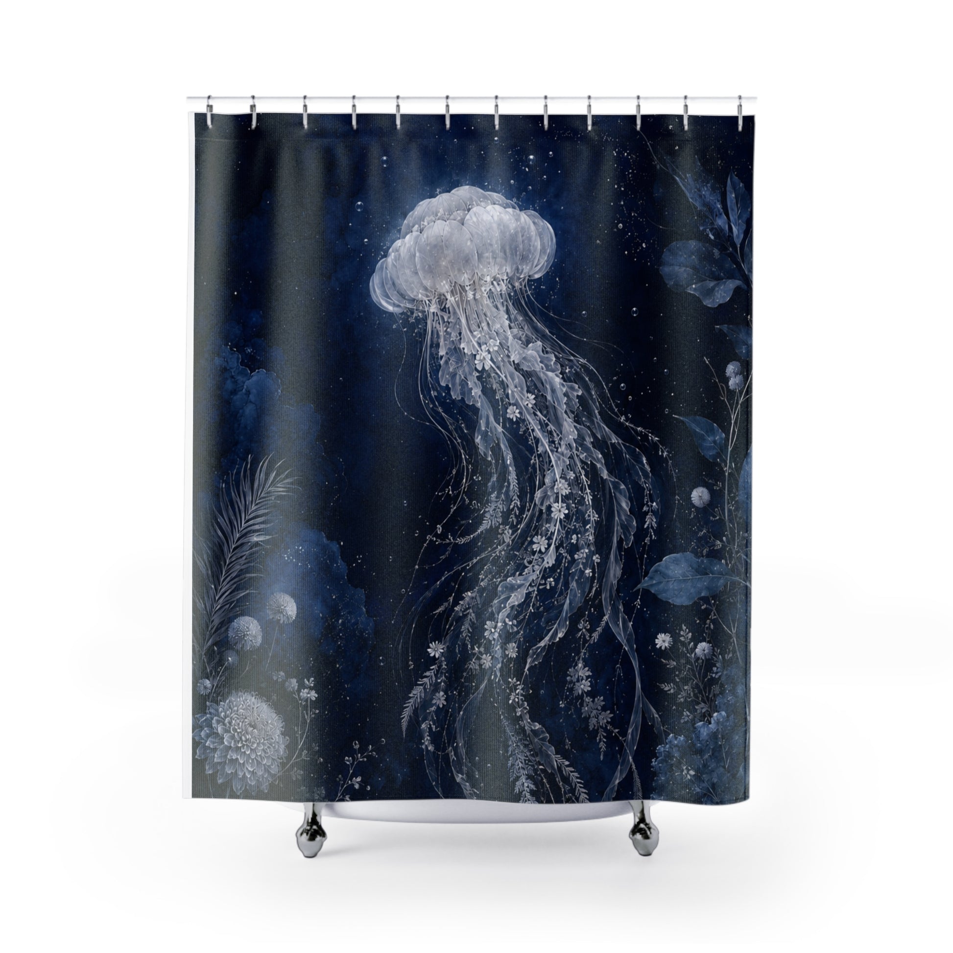 A shower curtain featuring a dark navy blue underwater design with a large white jellyfish, delicate seaweed, and small bubbles, hanging from silver rings on a white background.