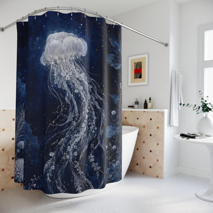 A navy blue shower curtain featuring a large white jellyfish underwater illustration, hanging in a modern white bathroom with a bathtub, tiled counter, and decorative wall art.