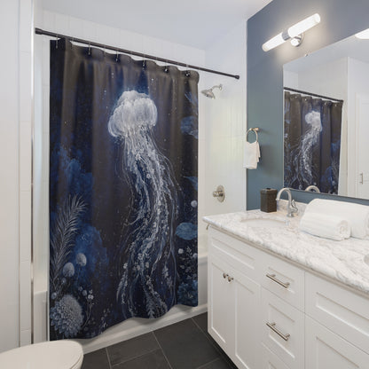 A dark blue and black shower curtain with a large white jellyfish and underwater plant illustration, hanging in a modern white and blue bathroom next to a marble vanity.