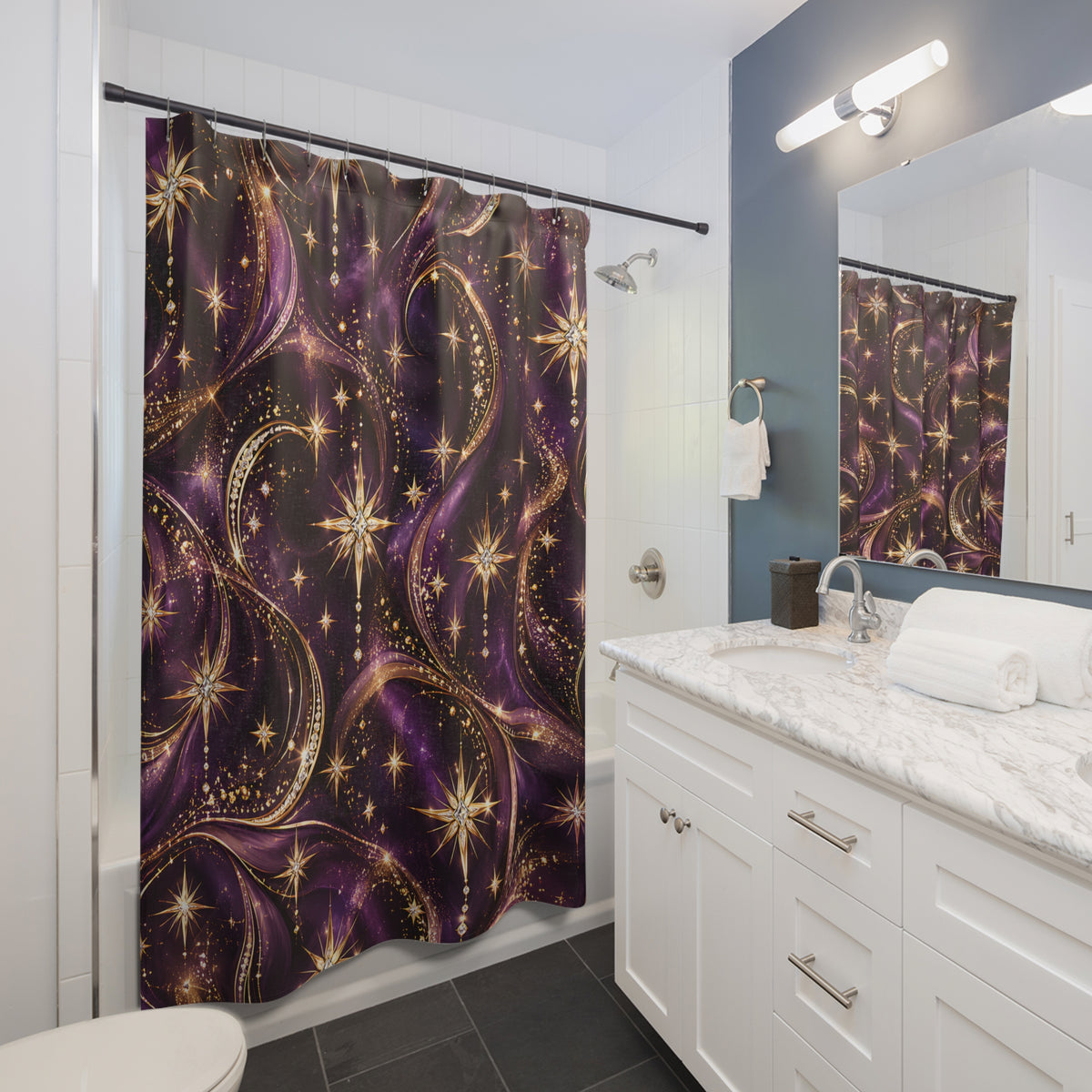 A purple and gold shower curtain with a swirling galaxy pattern hanging in a modern white bathroom with a marble vanity and mirror.