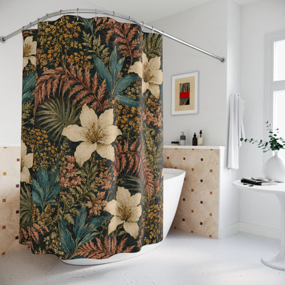 A tropical floral shower curtain with large cream lilies and green ferns on a dark background, hanging in a bright white bathroom next to a bathtub.