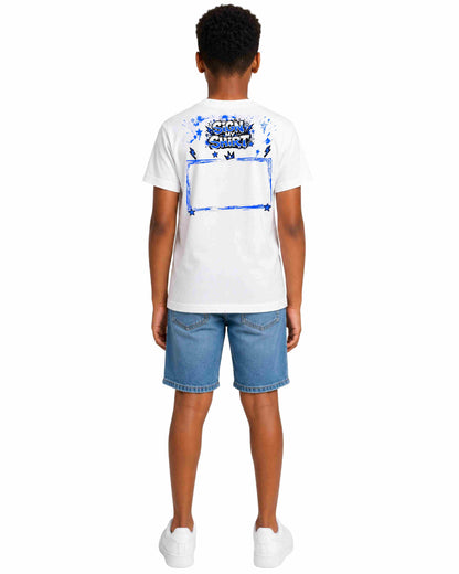 Person wearing a white t-shirt with a colorful design on the back and blue shorts against a white background