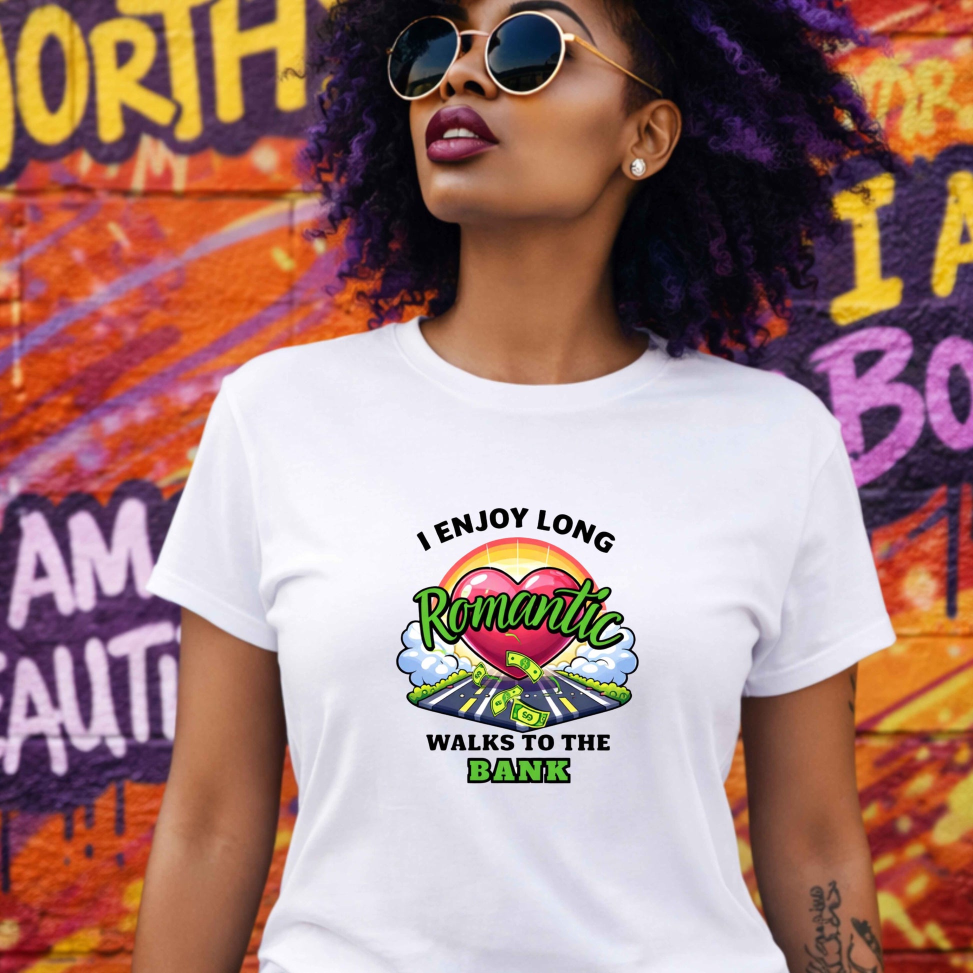 Woman wearing a white t-shirt with a colorful graphic and text, standing in front of a vibrant graffiti wall.
