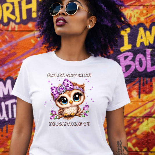 Woman wearing a white t-shirt with an owl graphic and text, standing in front of a colorful mural.