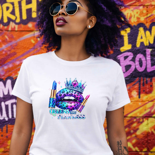 Woman wearing a white t-shirt with a colorful graphic and text, standing in front of a vibrant graffiti wall