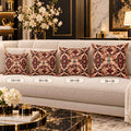 Luxury living room mockup featuring four decorative Pisces throw pillows arranged on a cream sofa in ascending sizes: 14×14, 16×16, 18×18, and 20×20. Each pillow has an ornate symmetrical design in burgundy, blush, cream, and gold with turquoise jewel accents, floral details, Pisces symbols, and two fish motifs. The room includes black, gold, and marble décor with white flowers and a coffee table in the foreground.